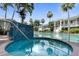 Inviting hot tub with teal tile design beside a larger pool amidst lush landscaping and resort-style amenities at 3702 54Th W Dr # 102, Bradenton, FL 34210