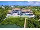 Magnificent aerial view of a modern estate with pool, dock, and lush landscaping at 3799 Flamingo Ave, Sarasota, FL 34242