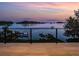 Waterfront balcony with composite decking and scenic views of a tranquil bay at sunset at 3799 Flamingo Ave, Sarasota, FL 34242