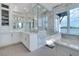Bathroom with marble countertop, modern fixtures, frameless shower and water view at 3799 Flamingo Ave, Sarasota, FL 34242