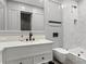 Modern bathroom featuring a white vanity, and a luxurious shower with white marble wall tiles and modern fixtures at 3799 Flamingo Ave, Sarasota, FL 34242