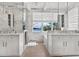 Luxurious marble bathroom featuring dual vanities, a soaking tub, and a stunning waterfront view at 3799 Flamingo Ave, Sarasota, FL 34242