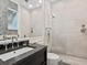 Elegant bathroom boasts a luxurious shower, and a sink with granite countertop and dark cabinetry with a neutral wallpaper at 3799 Flamingo Ave, Sarasota, FL 34242
