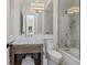 Bright bathroom features a tub-shower combination with glass door, a sink with a marble countertop, and classic fixtures at 3799 Flamingo Ave, Sarasota, FL 34242