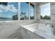 Luxurious bathtub with marble surround, modern fixtures and scenic water view at 3799 Flamingo Ave, Sarasota, FL 34242
