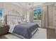 Bright bedroom features large windows with views, a patterned accent wall and a modern chandelier at 3799 Flamingo Ave, Sarasota, FL 34242