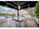 Relaxing covered patio with dining, lounging, and a beautiful view of the lake at 3799 Flamingo Ave, Sarasota, FL 34242