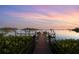 Scenic dock leading to the water, perfect for boating and enjoying waterfront living at sunset at 3799 Flamingo Ave, Sarasota, FL 34242
