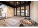Elegant home entrance with modern fire bowls flanking the doorway, leading into an open space with luxury interiors and water view at 3799 Flamingo Ave, Sarasota, FL 34242