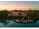 Beautiful waterfront estate at twilight, featuring lush greenery and a private dock at 3799 Flamingo Ave, Sarasota, FL 34242