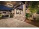 Grand covered entrance featuring stone accents, recessed lighting, and a landscaped garden, creating a welcoming and luxurious approach at 3799 Flamingo Ave, Sarasota, FL 34242
