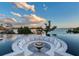 Amazing fire pit surrounded by in-pool seating with a beautiful waterfront view at 3799 Flamingo Ave, Sarasota, FL 34242