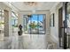 Stunning foyer with marble floors, chandelier, and floor-to-ceiling windows overlooking the water at 3799 Flamingo Ave, Sarasota, FL 34242