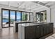 Spacious kitchen features an island, marble countertops, modern appliances, and waterfront views at 3799 Flamingo Ave, Sarasota, FL 34242