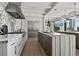 Bright, modern kitchen with marble countertops, stainless steel appliances, and large center island at 3799 Flamingo Ave, Sarasota, FL 34242