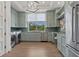 Well-equipped laundry room with modern washer and dryer, custom cabinets, and backyard views at 3799 Flamingo Ave, Sarasota, FL 34242