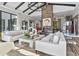 Open concept living room with stone fireplace, modern furnishings, and hardwood floors at 3799 Flamingo Ave, Sarasota, FL 34242