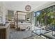 Spacious bedroom features a four-poster bed, stylish decor, and access to a private balcony at 3799 Flamingo Ave, Sarasota, FL 34242
