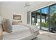 Relaxing bedroom with sliding glass doors to the outside, complemented by modern light fixture at 3799 Flamingo Ave, Sarasota, FL 34242