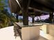 Well-equipped outdoor bar with bar-top seating features outdoor lighting and panoramic views of the backyard and sea at 3799 Flamingo Ave, Sarasota, FL 34242