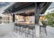 Well-appointed outdoor bar and seating area with countertop, and stunning views of the pool and backyard at 3799 Flamingo Ave, Sarasota, FL 34242