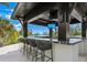 Entertain guests at the outdoor bar, complete with seating, granite countertops, and waterfront views at 3799 Flamingo Ave, Sarasota, FL 34242