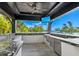 Enjoy the outdoor kitchen featuring stainless steel appliances and granite countertops with waterfront views at 3799 Flamingo Ave, Sarasota, FL 34242