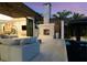 Cozy outdoor lounge area featuring a fireplace, comfortable seating, and lush landscaping at 3799 Flamingo Ave, Sarasota, FL 34242