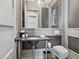 Elegant powder room with marble countertop, decorative mirror, and modern fixtures at 3799 Flamingo Ave, Sarasota, FL 34242