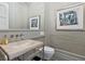 Stylish powder room featuring unique sink, modern fixtures and art at 3799 Flamingo Ave, Sarasota, FL 34242