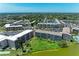 Panoramic aerial showcasing multiple condo buildings, community pool, lake and beautiful landscaping at 3801 Lake Bayshore Dr # H413, Bradenton, FL 34205