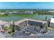 Aerial view highlighting condo buildings, parking, lakeside location, and lush green surroundings at 3801 Lake Bayshore Dr # H413, Bradenton, FL 34205