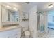 Clean bathroom with vanity, neutral tiling, and shower with curtain at 3801 Lake Bayshore Dr # H413, Bradenton, FL 34205