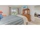 Comfortable bedroom includes a dresser, TV, and a sliding glass door to the balcony at 3801 Lake Bayshore Dr # H413, Bradenton, FL 34205