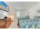 Charming bedroom with two twin beds, a TV, and a dresser against a clean white wall at 3801 Lake Bayshore Dr # H413, Bradenton, FL 34205