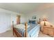 Relaxing bedroom with natural light and a wooden-framed bed with coastal-themed decor at 3801 Lake Bayshore Dr # H413, Bradenton, FL 34205