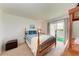 Cozy bedroom with a wooden-framed bed, balcony access, and calming natural light at 3801 Lake Bayshore Dr # H413, Bradenton, FL 34205