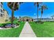 Exterior shot of the community clubhouse, landscaped grounds, and convenient parking at 3801 Lake Bayshore Dr # H413, Bradenton, FL 34205