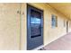 The condo's front door with address number is located on the side of a tan stucco building at 3801 Lake Bayshore Dr # H413, Bradenton, FL 34205