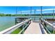 Community pier along a scenic lake, featuring a covered seating area and boat access at 3801 Lake Bayshore Dr # H413, Bradenton, FL 34205