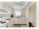 Efficient kitchen features white appliances, updated cabinets, and a window over the sink at 3801 Lake Bayshore Dr # H413, Bradenton, FL 34205