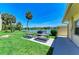 Outdoor barbecue and picnic area with tables, grill, lake view, and community landscaping at 3801 Lake Bayshore Dr # H413, Bradenton, FL 34205