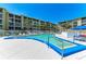 Inviting community pool surrounded by a sun deck, lounge chairs, and well-maintained landscaping at 3801 Lake Bayshore Dr # H413, Bradenton, FL 34205