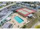 Aerial view of community pool, tennis courts, and clubhouse with ample parking at 4116 43Rd W Ave, Bradenton, FL 34205
