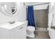 Clean bathroom featuring a white vanity, toilet, and shower with a blue curtain, creating a functional space at 4116 43Rd W Ave, Bradenton, FL 34205