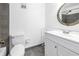 Compact bathroom featuring a white vanity, toilet, and walk-in shower, offering a functional and well-maintained space at 4116 43Rd W Ave, Bradenton, FL 34205