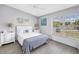 Bright bedroom with white furnishings, including a bed, dressers, and windows offering natural light and pleasant views at 4116 43Rd W Ave, Bradenton, FL 34205