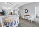 Bright dining area with granite countertops, white cabinetry, and a charming floral tablecloth at 4116 43Rd W Ave, Bradenton, FL 34205