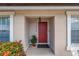 Inviting front entrance with a red door, potted plant, and manicured landscaping at 4116 43Rd W Ave, Bradenton, FL 34205