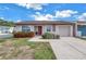 Charming home featuring a well-kept lawn, colorful shrubbery, and a private driveway at 4116 43Rd W Ave, Bradenton, FL 34205